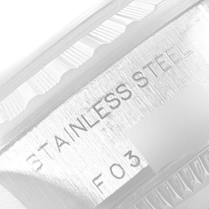 This image shows the side engraving on the case of a Rolex Date 79240 Women's Stainless Steel Pink Dial 79240 Women's Stainless Steel Pink Dial model, indicating "STAINLESS STEEL" material.