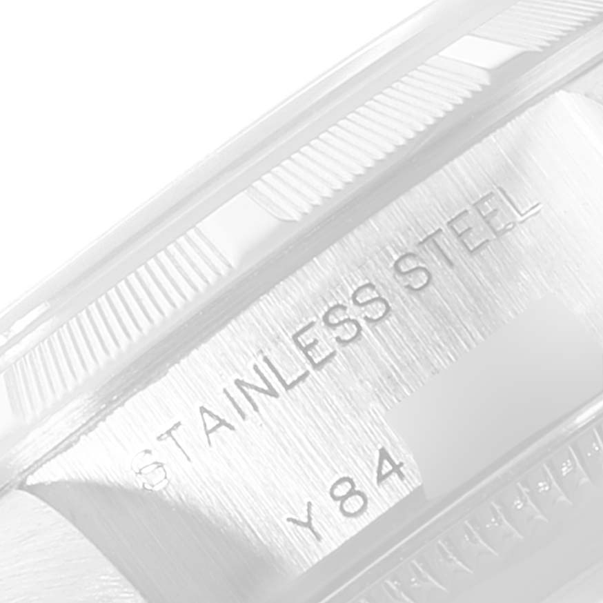 This close-up image shows the side view of the case back of a Rolex Date 79190 Women's Stainless Steel Pink Dial 79190 Women's Stainless Steel Pink Dial model, highlighting the "STAINLESS STEEL" engraving.