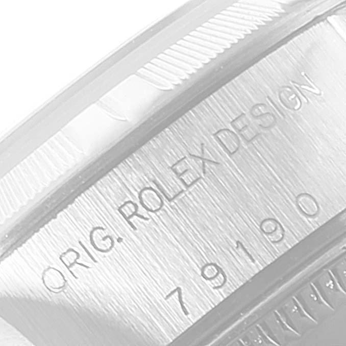 This image shows an angled view of the serial number and case marking on the side of a Rolex Date 79190 Women's Stainless Steel Pink Dial 79190 Women's Stainless Steel Pink Dial watch model.