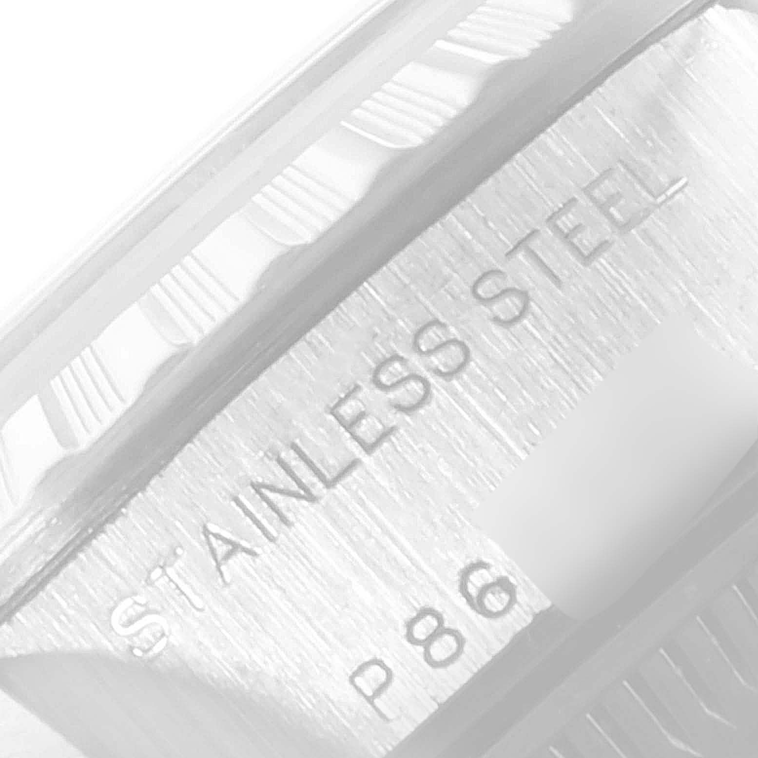 The image shows a close-up of the edge of the bezel and engraved case of a Rolex Date 79240 Women
s Stainless Steel Silver Dial 79240 Women
s Stainless Steel Silver Dial model watch, indicating "Stainless Steel."
