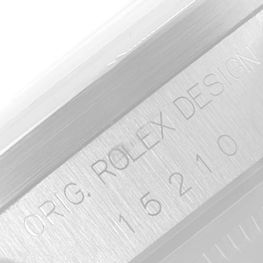 This image shows a close-up view of the inner bezel of a Rolex Date 15210 Men's Stainless Steel Silver Dial 15210 Men's Stainless Steel Silver Dial model watch, displaying the "ORIG. ROLEX DESIGN" engraving and model number 15210.
