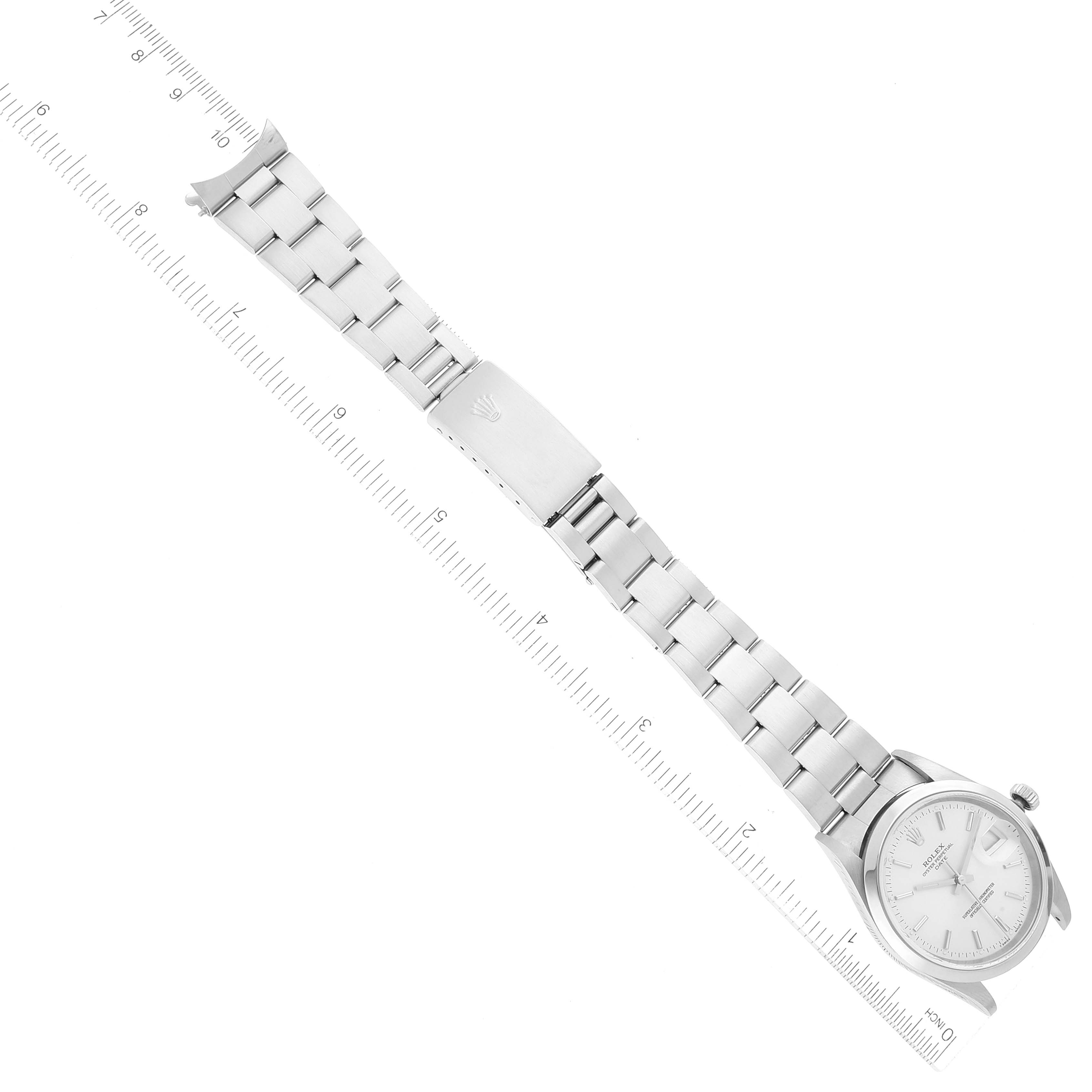 The image shows a Rolex Date 15200 Men's Stainless Steel Silver Dial 15200 Men's Stainless Steel Silver Dial watch laid flat, displaying the face, bracelet, and clasp with a ruler for scale.