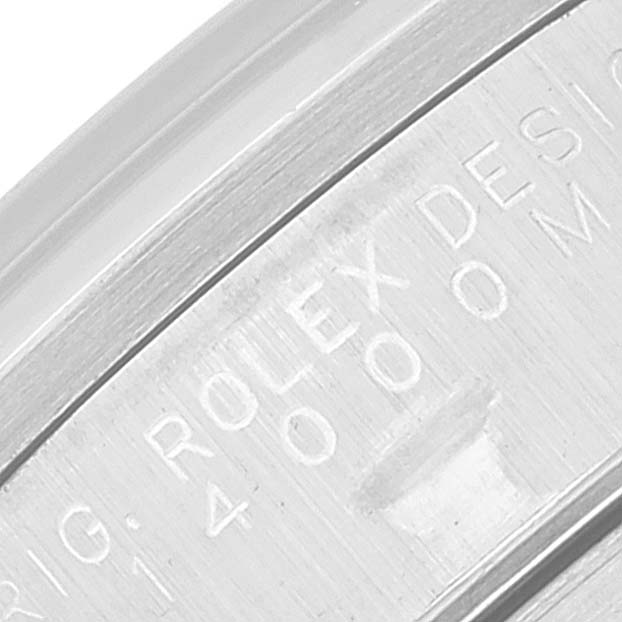 The image shows a close-up of the engraved inner bezel of a Rolex Date 15200 Men's Stainless Steel Silver Dial 15200 Men's Stainless Steel Silver Dial model watch.