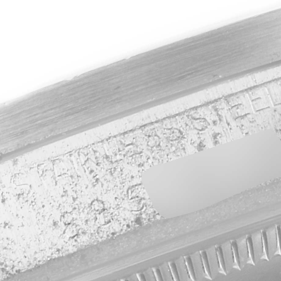 The image shows a close-up of the engraved serial number and "STAINLESS STEEL" marking on the bracelet of the Vintage Collection model by Rolex.
