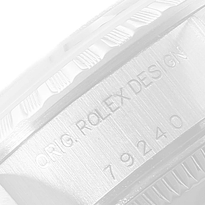 The image shows a close-up angle of the side of the casing on a Rolex Date 79240 Women
s Stainless Steel White Dial 79240 Women
s Stainless Steel White Dial model watch, revealing the engraved model number "79240".