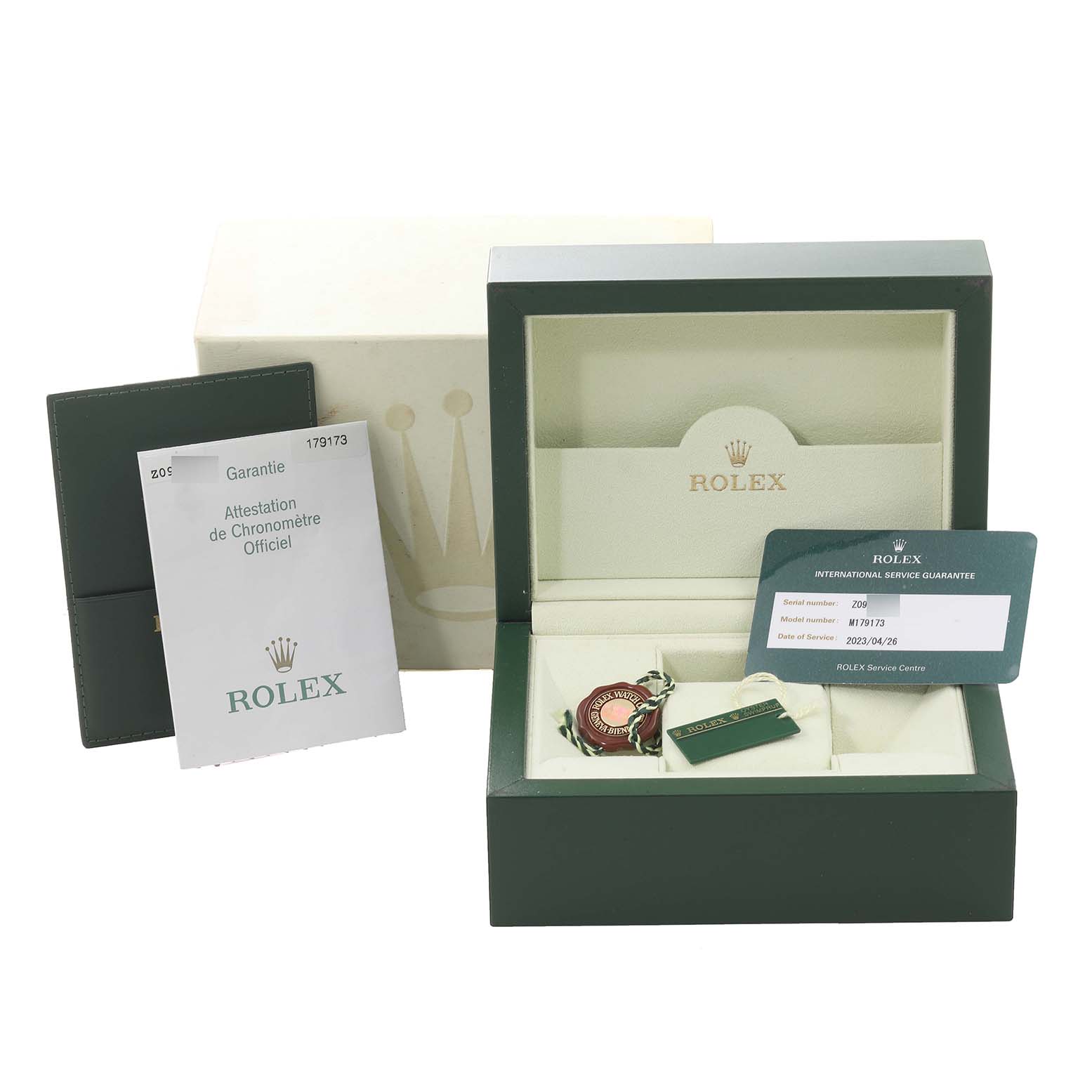 The image shows the packaging accessories for a Rolex Datejust 179173 Women's Steel and Gold (two tone) Champagne Dial 179173 Women's Steel and Gold (two tone) Champagne Dial watch, including the box, warranty card, and documentation.