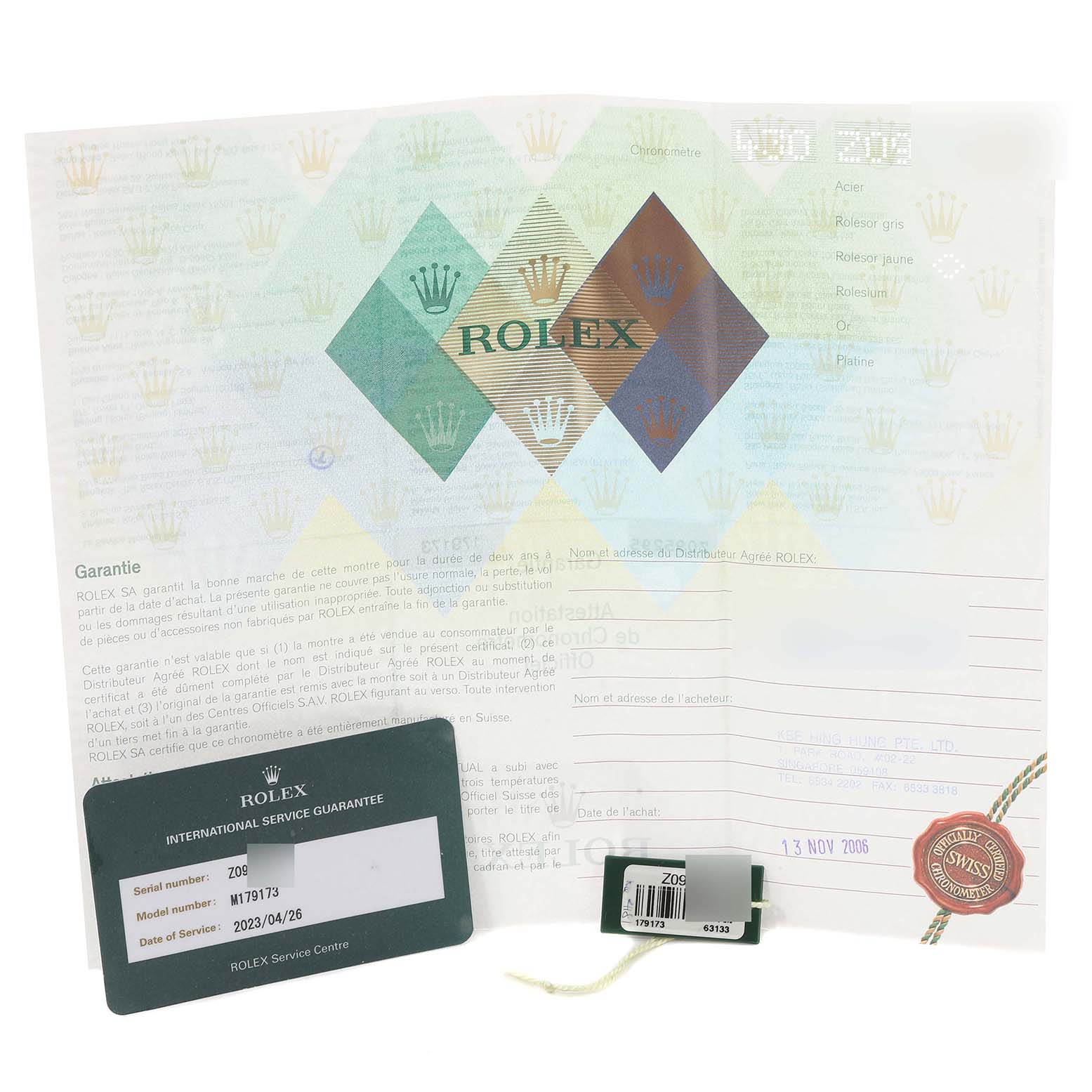 The image shows documents and a guarantee card for the Rolex Datejust 179173 Women's Steel and Gold (two tone) Champagne Dial 179173 Women's Steel and Gold (two tone) Champagne Dial watch.