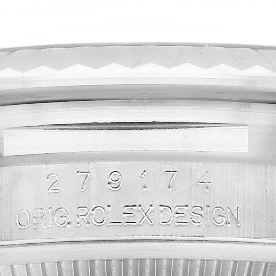 The image shows the engraved side of a Rolex Datejust 279174 Women
s Stainless Steel White Dial 279174 Women
s Stainless Steel White Dial case with part of the bezel.