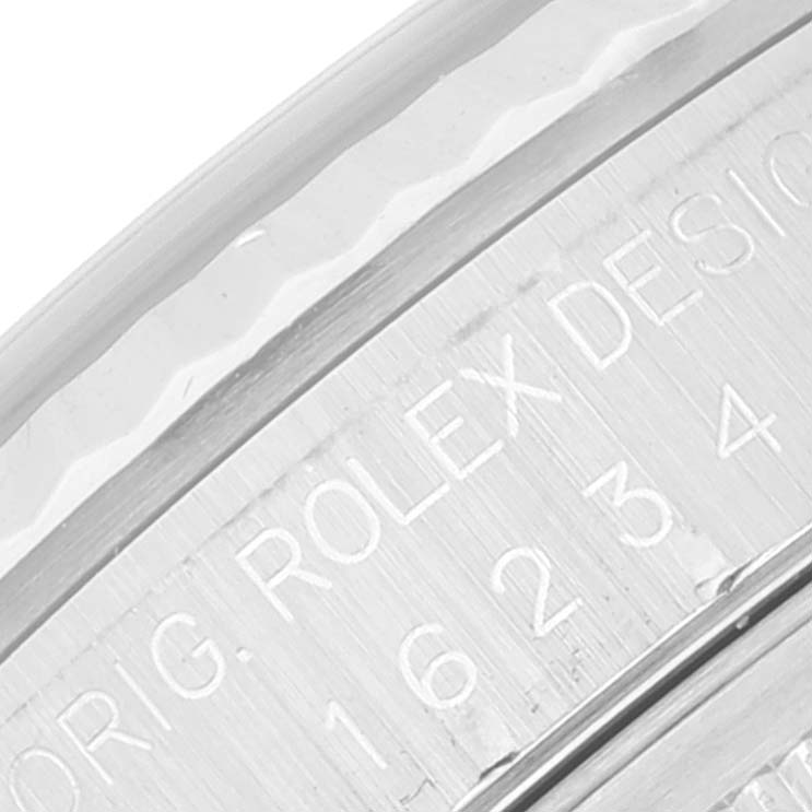 The image shows a close-up of the engraved details on the bezel of a Rolex Datejust 16234 Men's Stainless Steel Black Dial 16234 Men's Stainless Steel Black Dial watch.