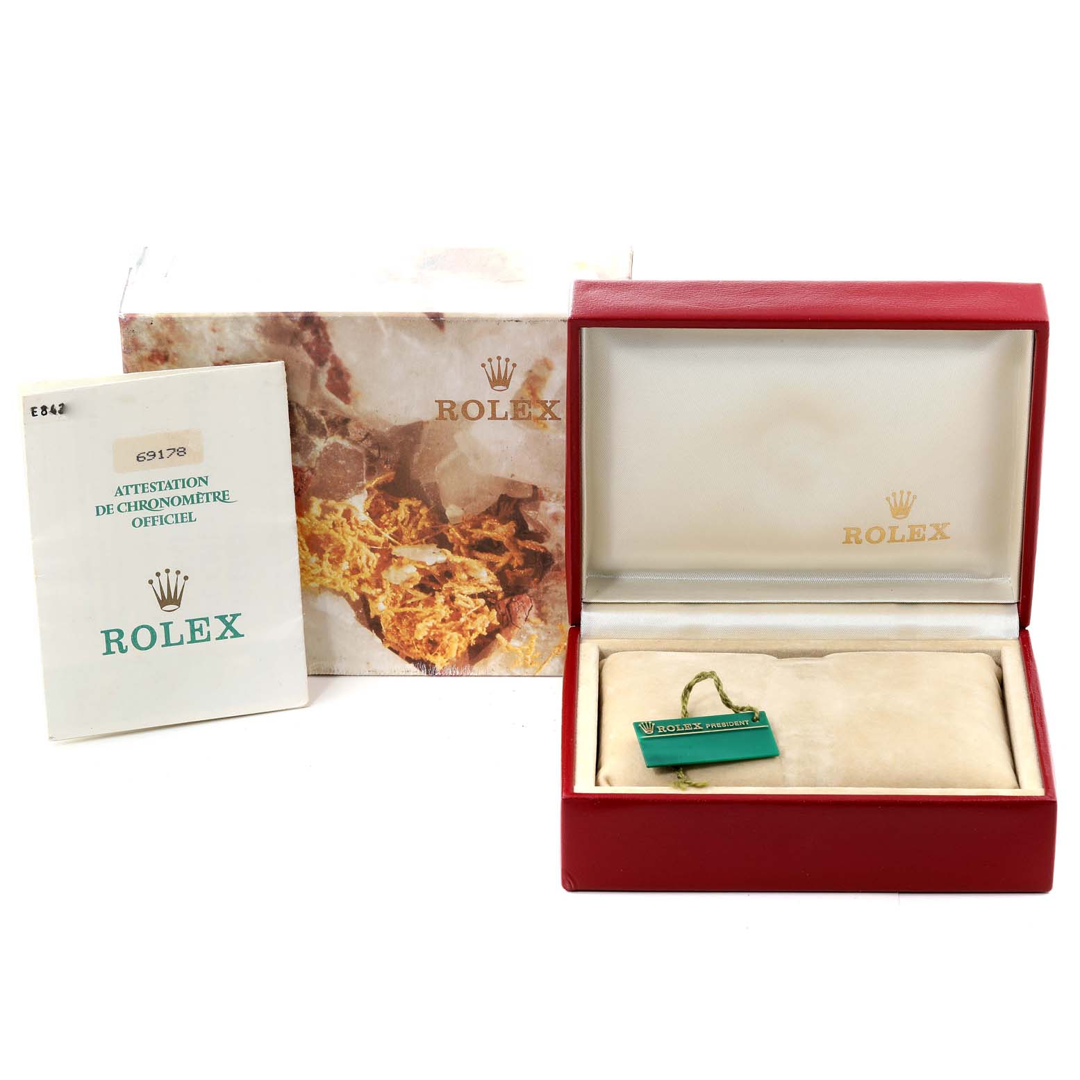 The image shows the packaging and accessories for a Rolex President 69178 Women
s Yellow Gold Champagne Dial 69178 Women
s Yellow Gold Champagne Dial model, including the box, manual, and tags.