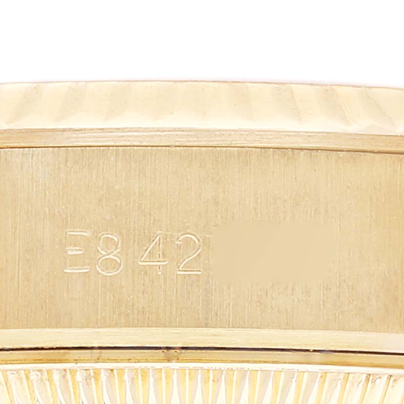 This close-up image shows the side of the Rolex President 69178 Women
s Yellow Gold Champagne Dial 69178 Women
s Yellow Gold Champagne Dial model watch case with engraved serial numbers.