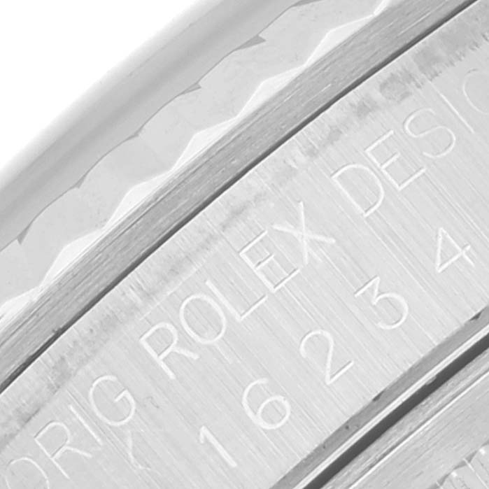 This close-up image shows the engraved edge of the bezel and case of a Rolex Datejust 16234 Men's Stainless Steel Blue Dial 16234 Men's Stainless Steel Blue Dial watch.