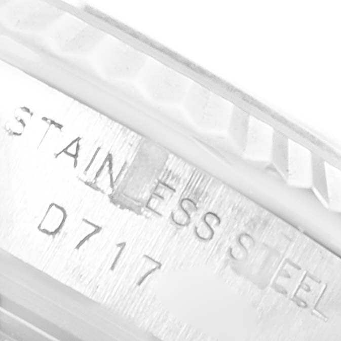 The image shows a close-up of the stainless steel engraving and fluted bezel of a Rolex Datejust 179174 Women
s Stainless Steel Mother of Pearl Dial 179174 Women
s Stainless Steel Mother of Pearl Dial watch.