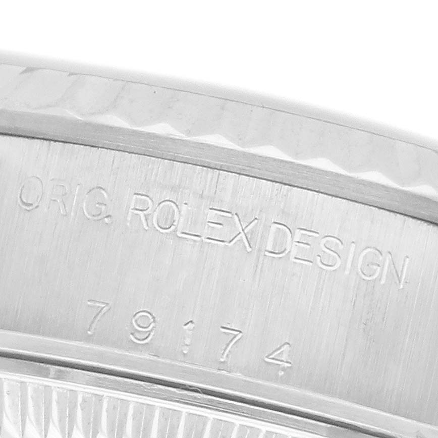 The image shows a close-up of the case edge of a Rolex Datejust 79174 Women
s Stainless Steel Silver Dial 79174 Women
s Stainless Steel Silver Dial, highlighting "ORIG. ROLEX DESIGN" and the model number.