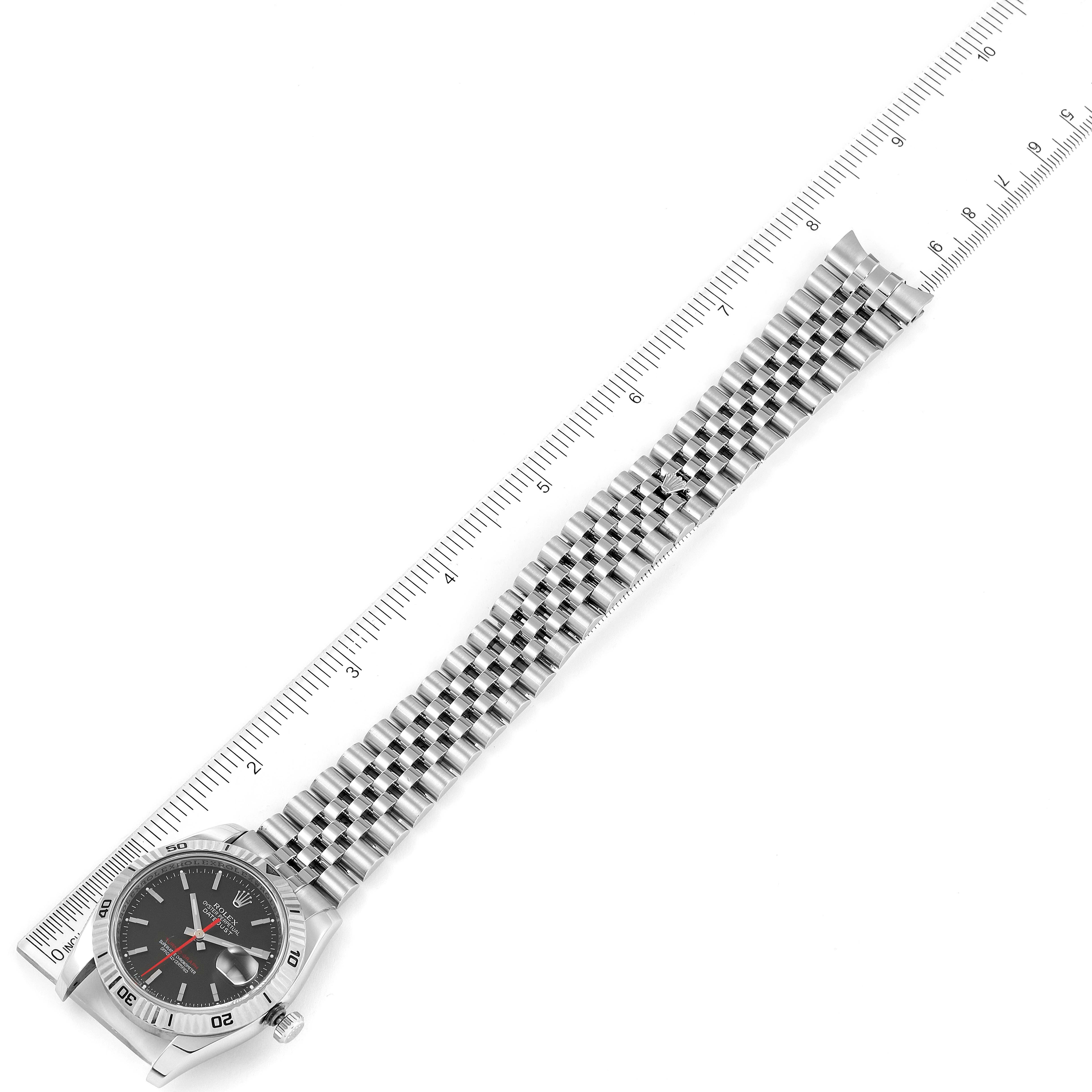 The image shows the Rolex Turn-o-Graph 116264 Men's Stainless Steel Black Dial 116264 Men's Stainless Steel Black Dial watch laid flat, highlighting the face, bezel, and metal bracelet against a ruler for scale.