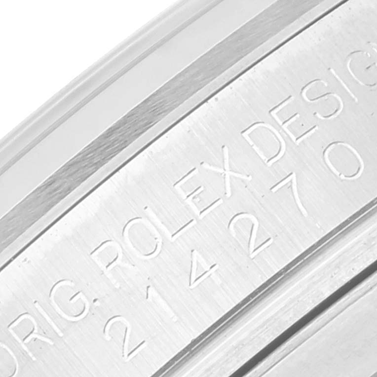 The image shows a close-up of the engraved serial number and branding on the side of a Rolex Explorer 214270 Men
s Stainless Steel Black Dial 214270 Men
s Stainless Steel Black Dial watch case.