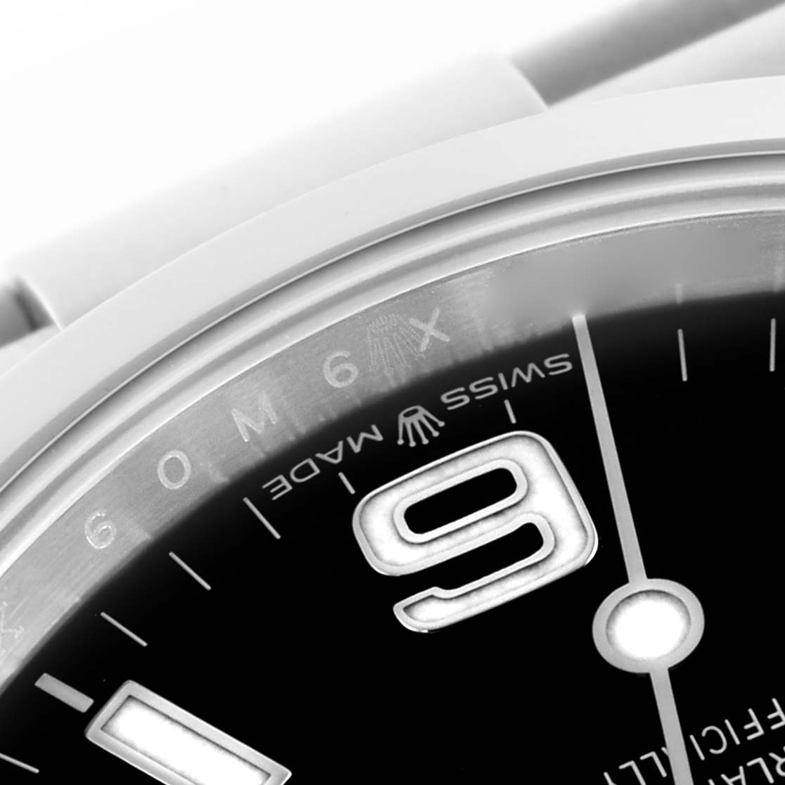 The image shows a close-up of the Rolex Explorer 224270 Men
s Stainless Steel Black Dial 224270 Men
s Stainless Steel Black Dial watch face, highlighting the "9" numeral and part of the bezel.