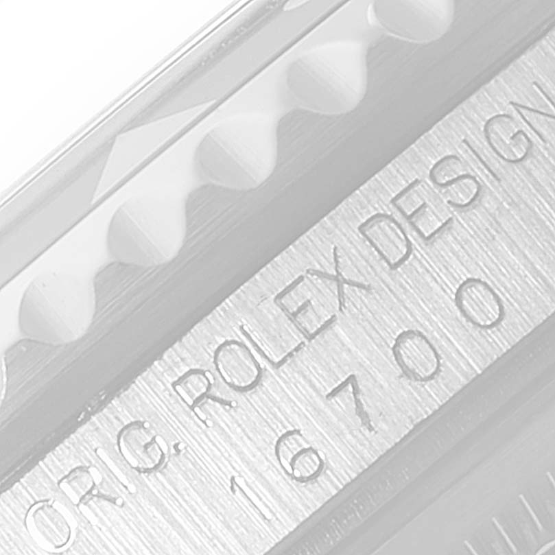 This image shows a close-up of the model number and part of the bezel on a Rolex GMT-Master 16700 Men's Stainless Steel Black Dial 16700 Men's Stainless Steel Black Dial watch.