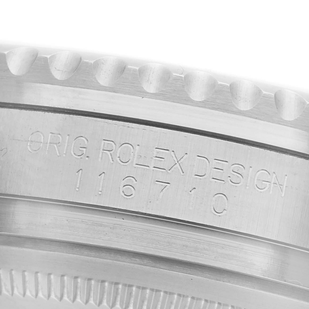 The image shows a close-up of the Rolex GMT-Master 116710BLNR Men
s Stainless Steel Black Dial 116710BLNR Men
s Stainless Steel Black Dial
s case edge with engraved model details.