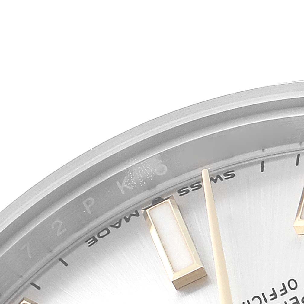 The image shows a close-up angle of the dial of a Mid-Size Rolex watch, focusing on the markers, hands, and part of the "Swiss Made" text.