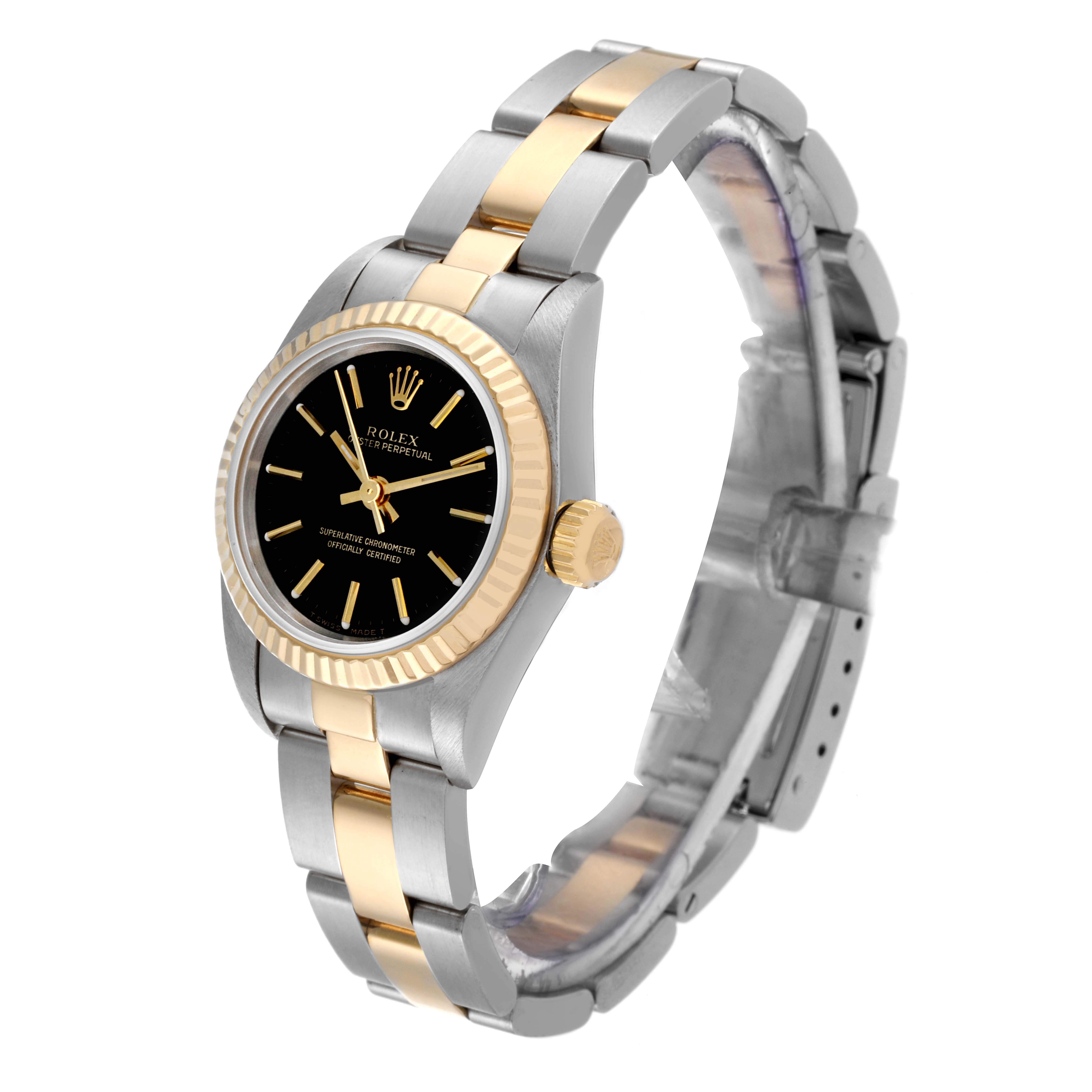 The image shows a Rolex Oyster Perpetual 67193 Women
s Steel and Gold (two tone) Black Dial 67193 Women
s Steel and Gold (two tone) Black Dial watch at an angle highlighting its face, crown, and bracelet, featuring a two-tone design.