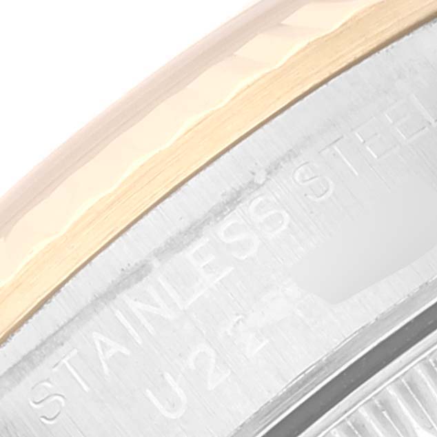 This image shows a close-up of the case back and part of the bezel of a Rolex Oyster Perpetual 67193 Women
s Steel and Gold (two tone) Black Dial 67193 Women
s Steel and Gold (two tone) Black Dial watch.