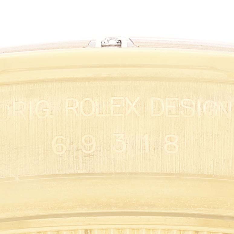 This image shows a close-up of the engraved side of a Rolex Pearlmaster 69318 Women
s Yellow Gold Mother of Pearl Dial 69318 Women
s Yellow Gold Mother of Pearl Dial watch.