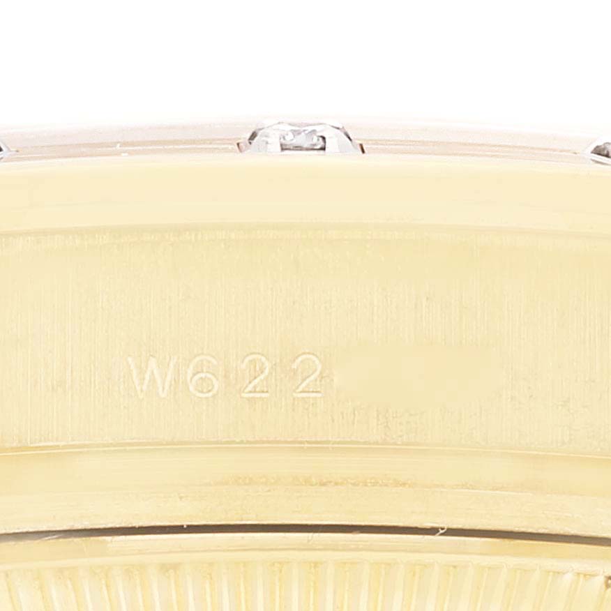 The image shows a close-up view of the side casing of a Rolex Pearlmaster 69318 Women
s Yellow Gold Mother of Pearl Dial 69318 Women
s Yellow Gold Mother of Pearl Dial watch, highlighting its serial number engraving.