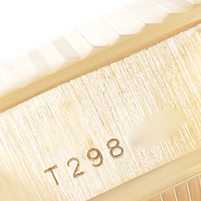 This close-up image shows the bezel and part of the serial number of a Rolex President 69178 Women
s Yellow Gold Champagne Dial 69178 Women
s Yellow Gold Champagne Dial model watch.