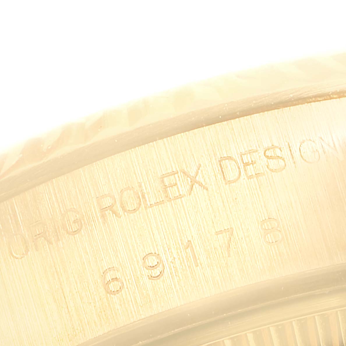 The image shows a close-up view of the side casing with engraved text on a Rolex President 69178 Women
s Yellow Gold Mother of Pearl Dial 69178 Women
s Yellow Gold Mother of Pearl Dial model watch.