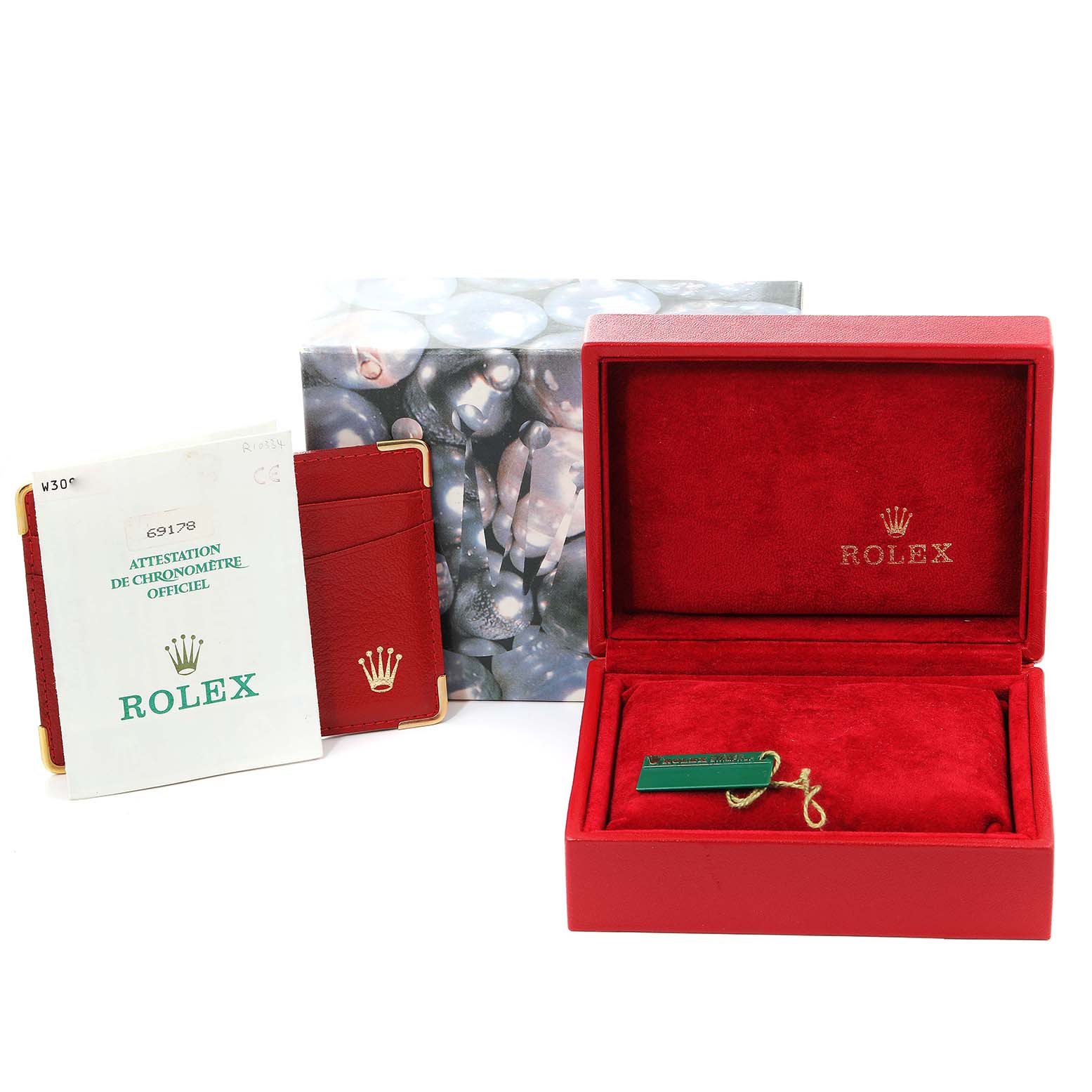 This image shows the packaging and accessories for a Rolex President 69178 Women
s Yellow Gold Mother of Pearl Dial 69178 Women
s Yellow Gold Mother of Pearl Dial model, including the box, booklet, and tags.