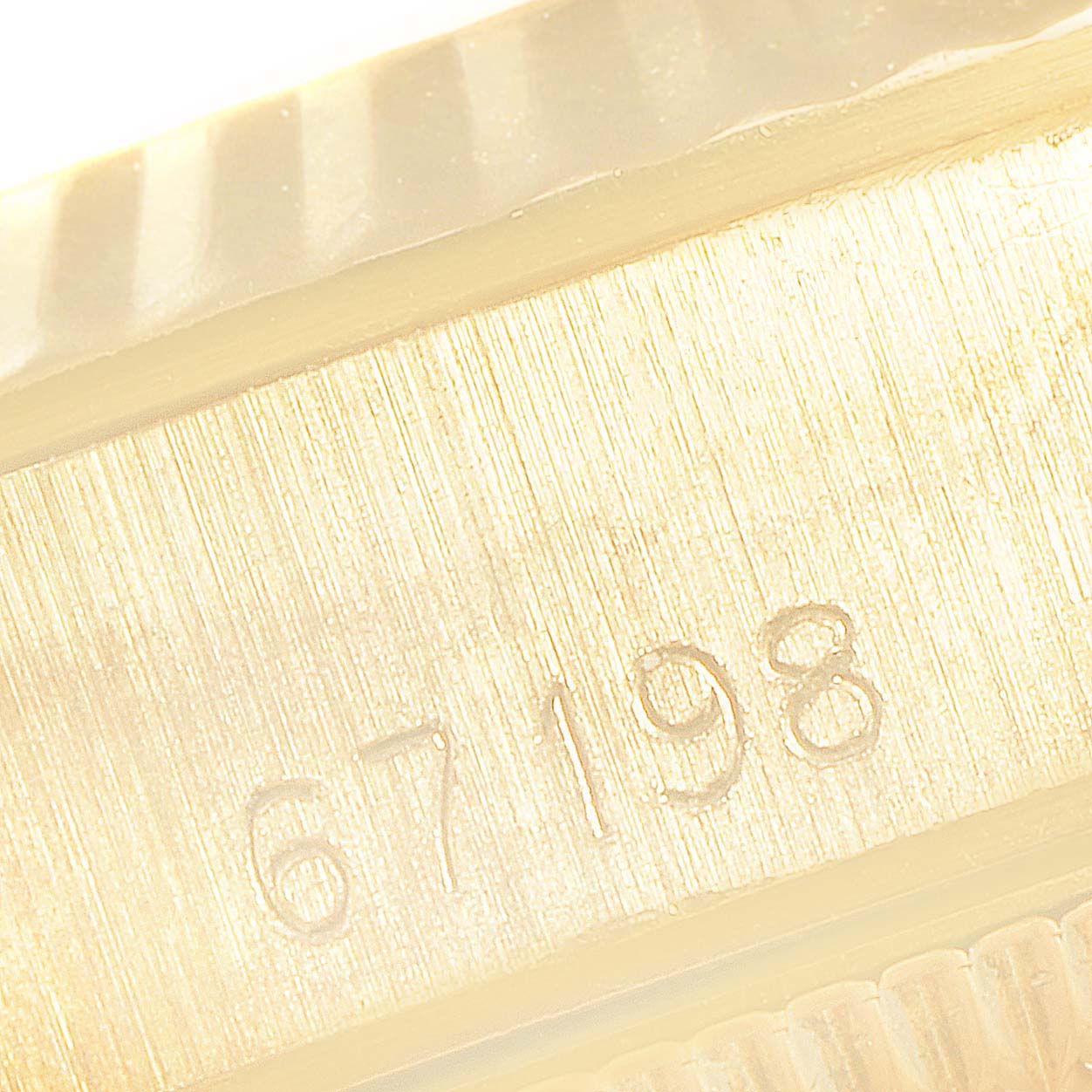 This close-up image shows the model number engraving (67198) on the case side of a Rolex President 67198 Women
s Yellow Gold Champagne Dial 67198 Women
s Yellow Gold Champagne Dial watch.