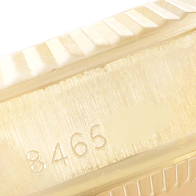 This close-up image shows the case side of a Rolex President 67198 Women
s Yellow Gold Champagne Dial 67198 Women
s Yellow Gold Champagne Dial model watch, highlighting the serial number engraving.