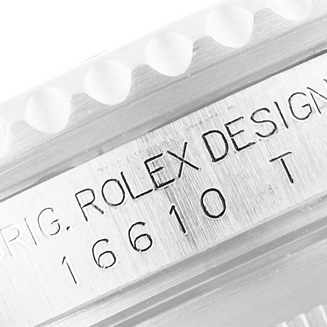 The image shows a close-up angle of the engraved model number and brand design name on a Rolex Submariner 16610 Men's Stainless Steel Black Dial 16610 Men's Stainless Steel Black Dial 16610.