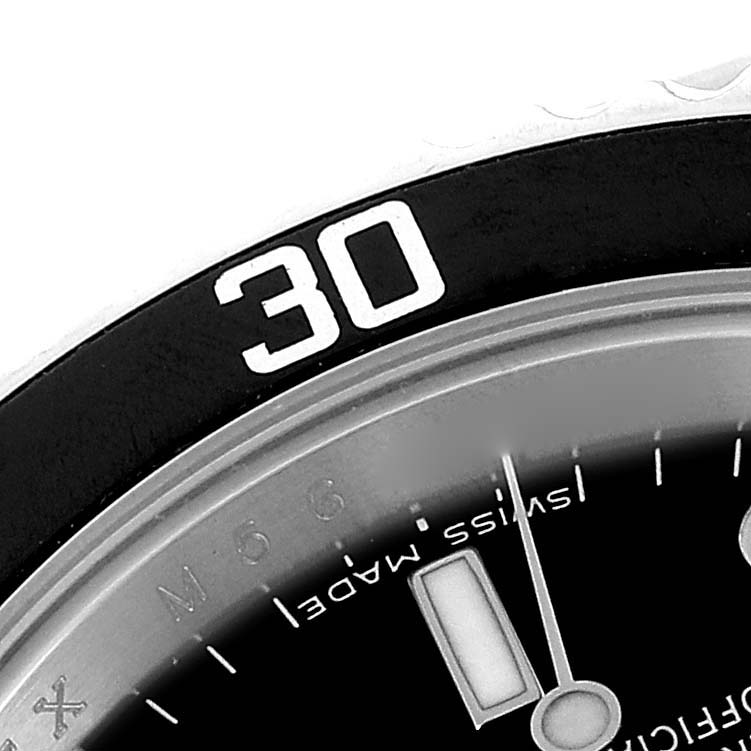 This close-up image shows the bezel and part of the dial of a Rolex Submariner 14060M Men
s Stainless Steel Black Dial 14060M Men
s Stainless Steel Black Dial watch.