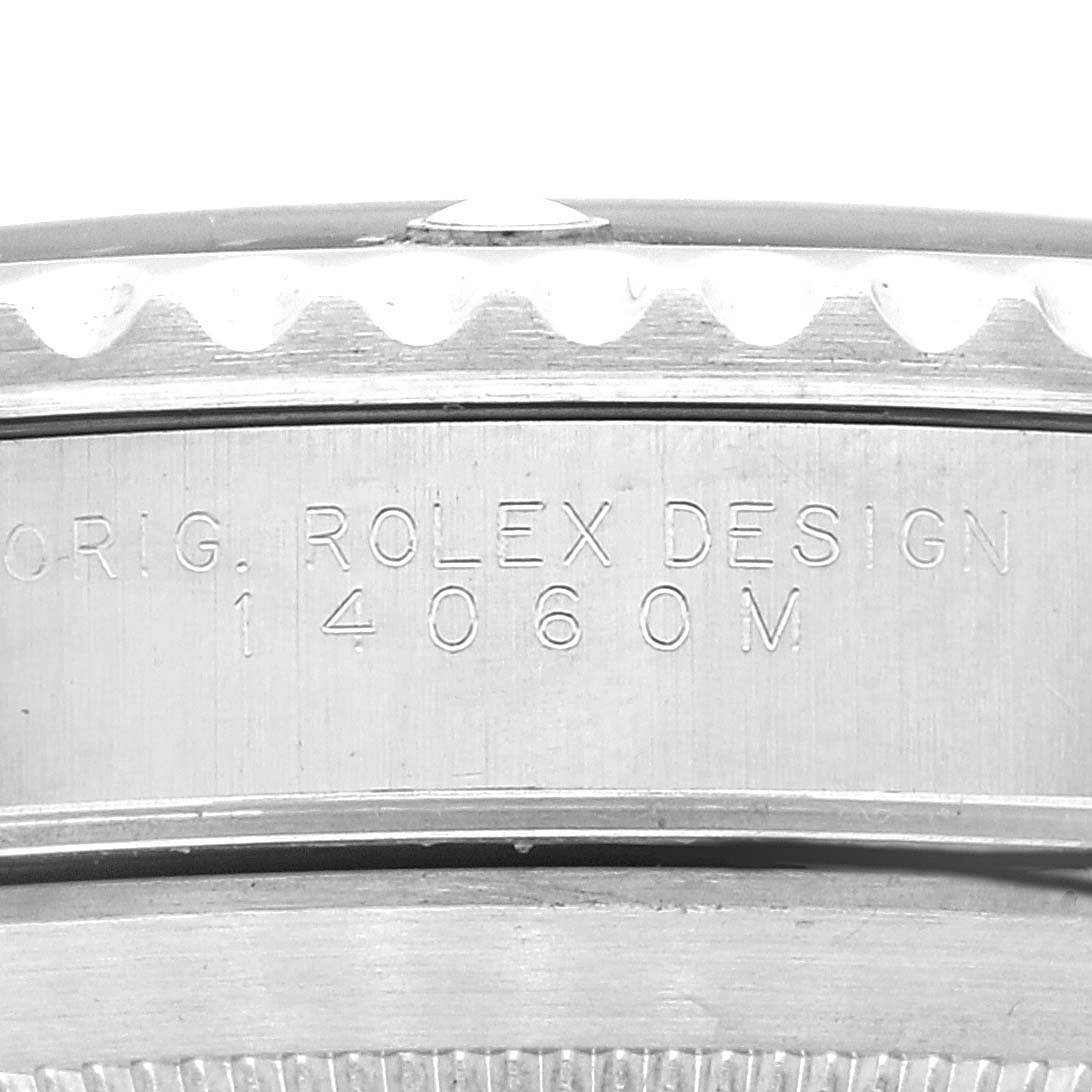 This image shows the side casing of a Rolex Submariner 14060M Men
s Stainless Steel Black Dial 14060M Men
s Stainless Steel Black Dial watch with the model number 14060M etched into it.