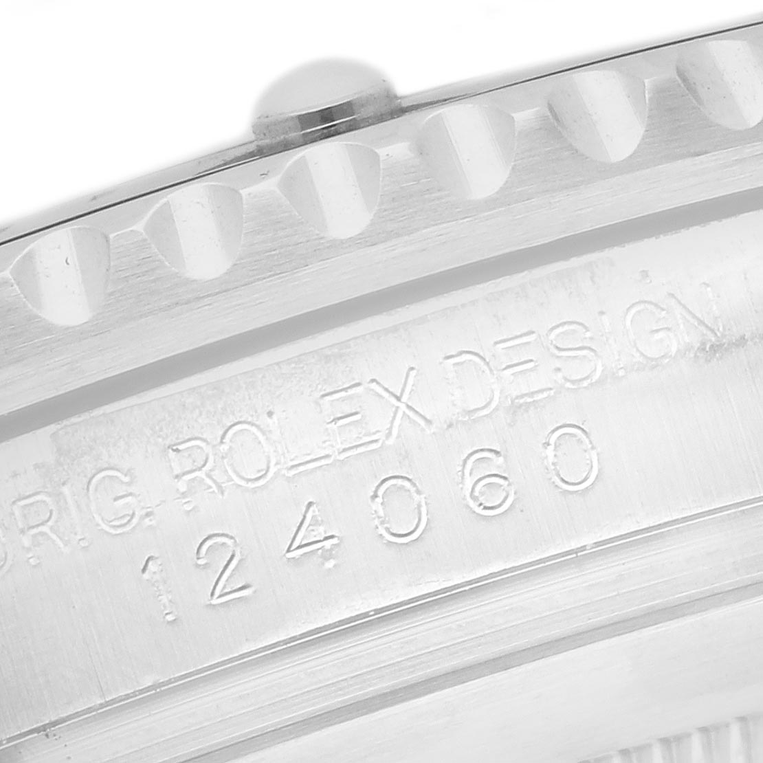 The image shows a close-up of the model number engraving on the side of the bezel of a Rolex Submariner 124060 Men
s Stainless Steel Black Dial 124060 Men
s Stainless Steel Black Dial.