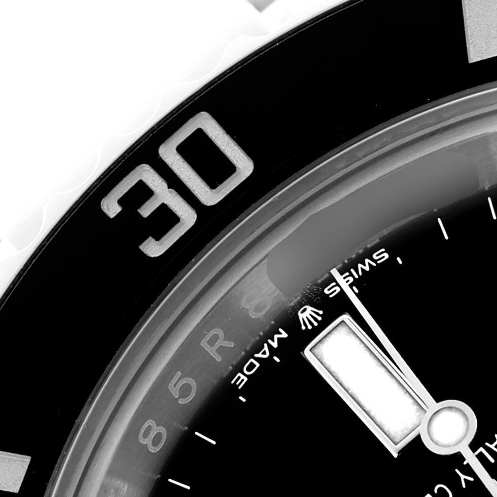 The image shows a close-up of the bezel and part of the dial of a Rolex Submariner 124060 Men
s Stainless Steel Black Dial 124060 Men
s Stainless Steel Black Dial, focusing on the "30" minute mark.