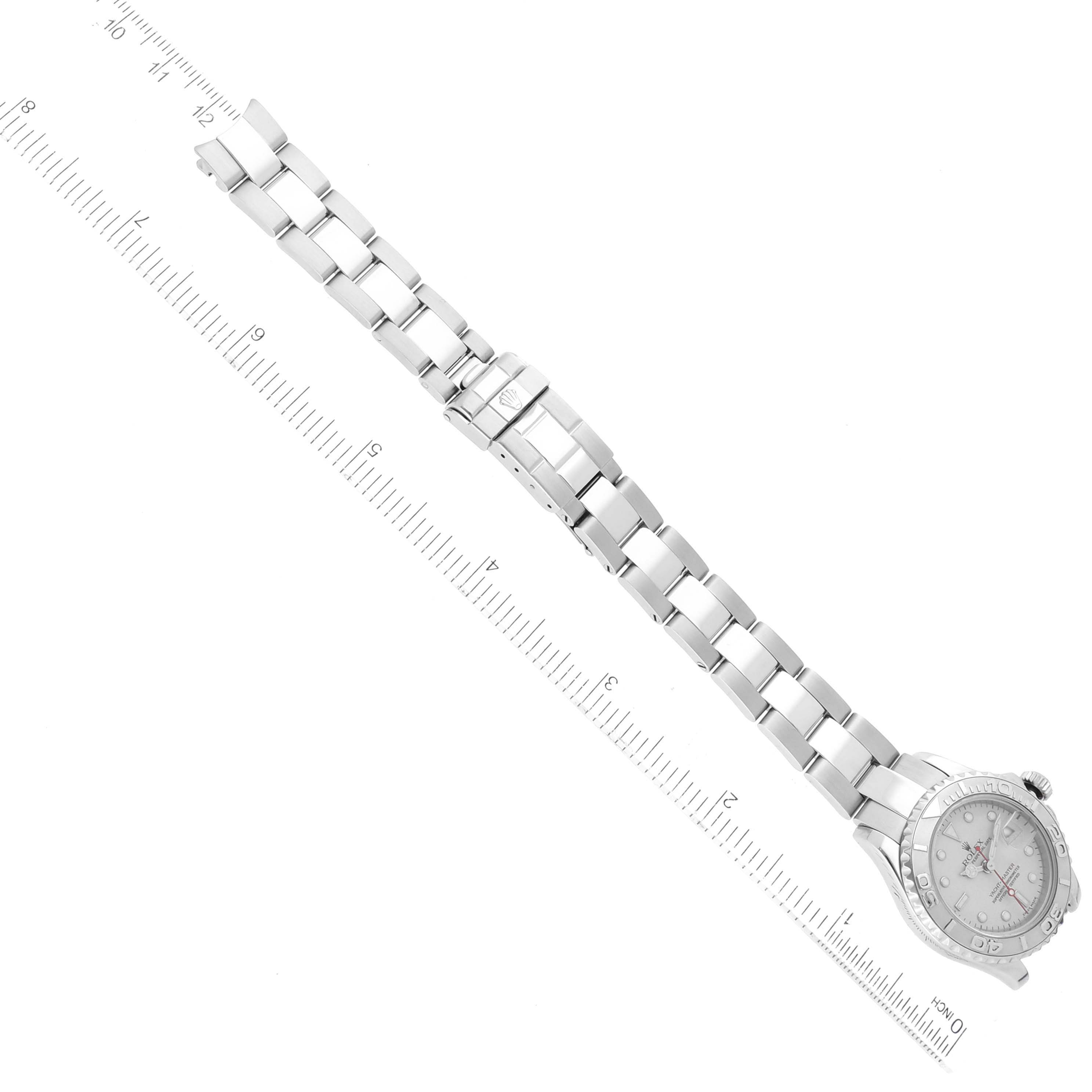 The image shows a Rolex Yacht-Master 169622 Women's Stainless Steel Silver Dial 169622 Women's Stainless Steel Silver Dial watch fully extended with a straight-on view, highlighting the face and bracelet alongside a ruler for scale.