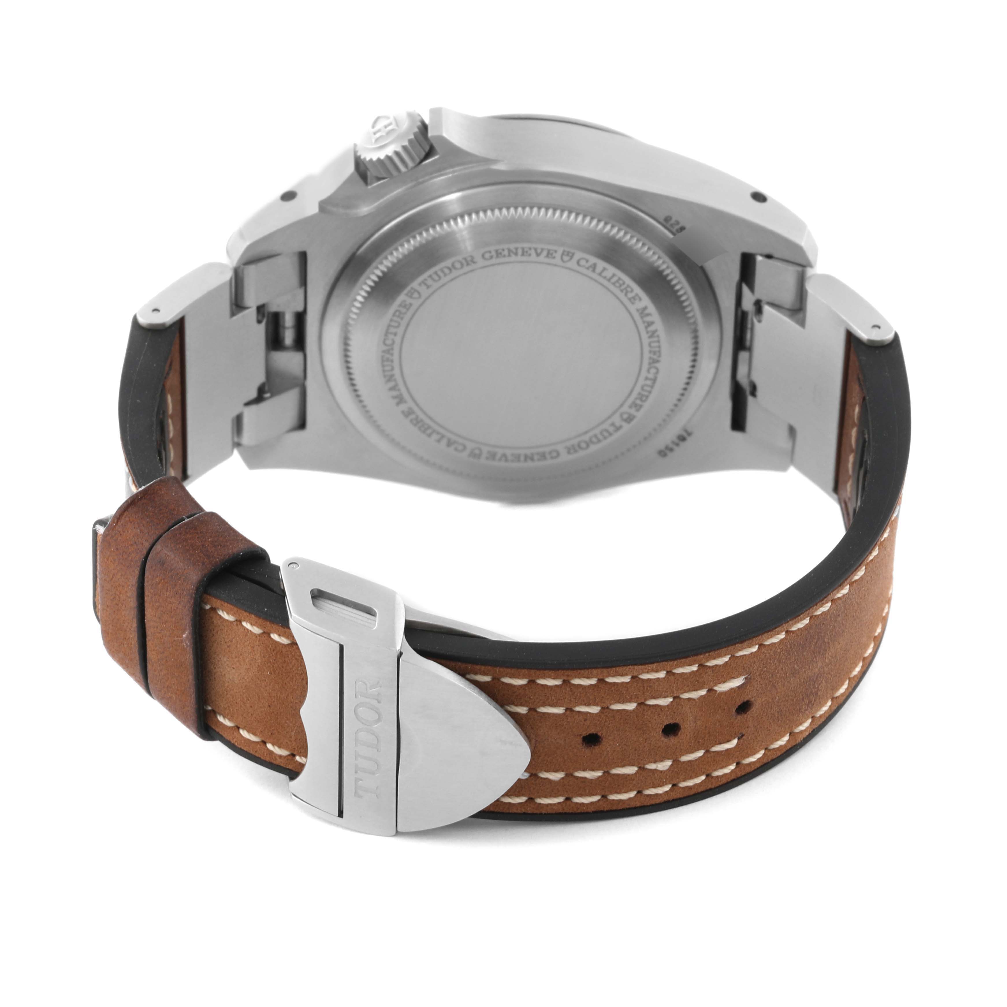 The image displays the back view of the Tudor Heritage Black Bay 70150 Men's Stainless Steel Black Dial 70150 Men's Stainless Steel Black Dial watch, showing the case, crown, and the brown leather strap with stitching.