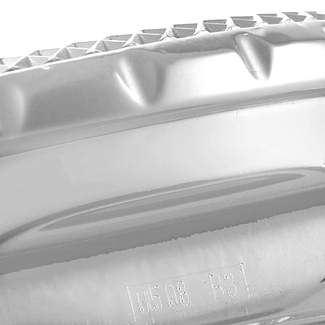 Close-up of the Breitling Bentley A13363 Men's Stainless Steel Black Dial A13363 Men's Stainless Steel Black Dial watch showing the bezel with its knurled pattern and part of the case edge including some engraved markings.