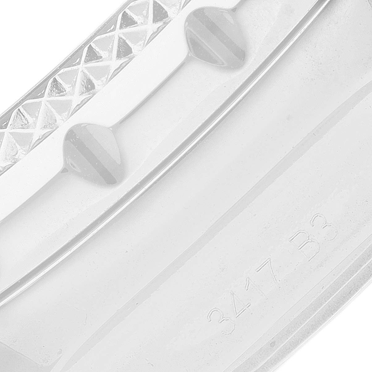 The image shows a close-up of the textured bezel and part of the case with engraving on the Bentley model by Breitling.