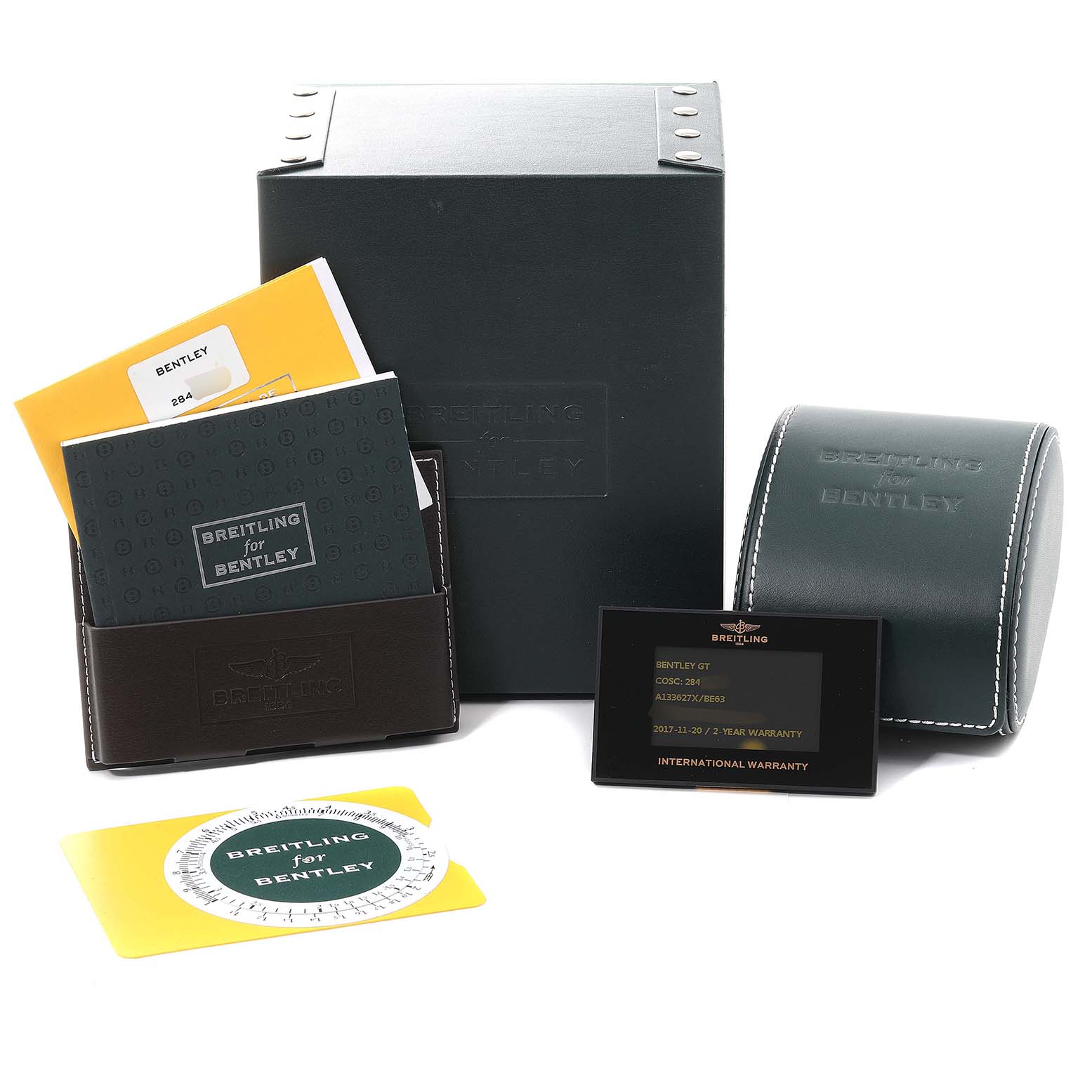 The image shows the packaging, warranty card, manuals, and a leather case for the Bentley model by Breitling.