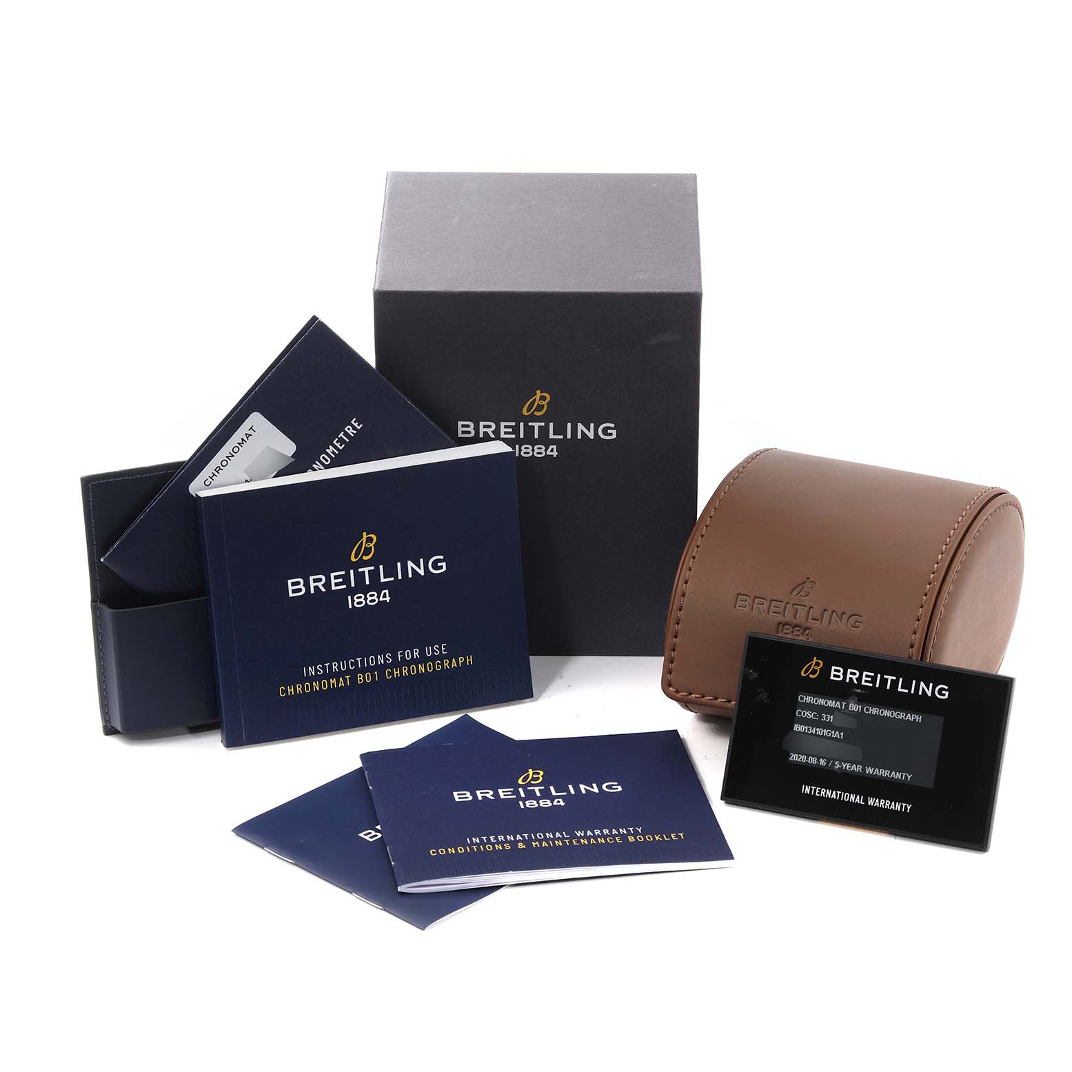 This image shows the accessories for a Breitling Chronomat IB0134 Men's Steel and Gold (two tone) Silver Dial IB0134 Men's Steel and Gold (two tone) Silver Dial watch, including manuals, box, leather case, and warranty card.