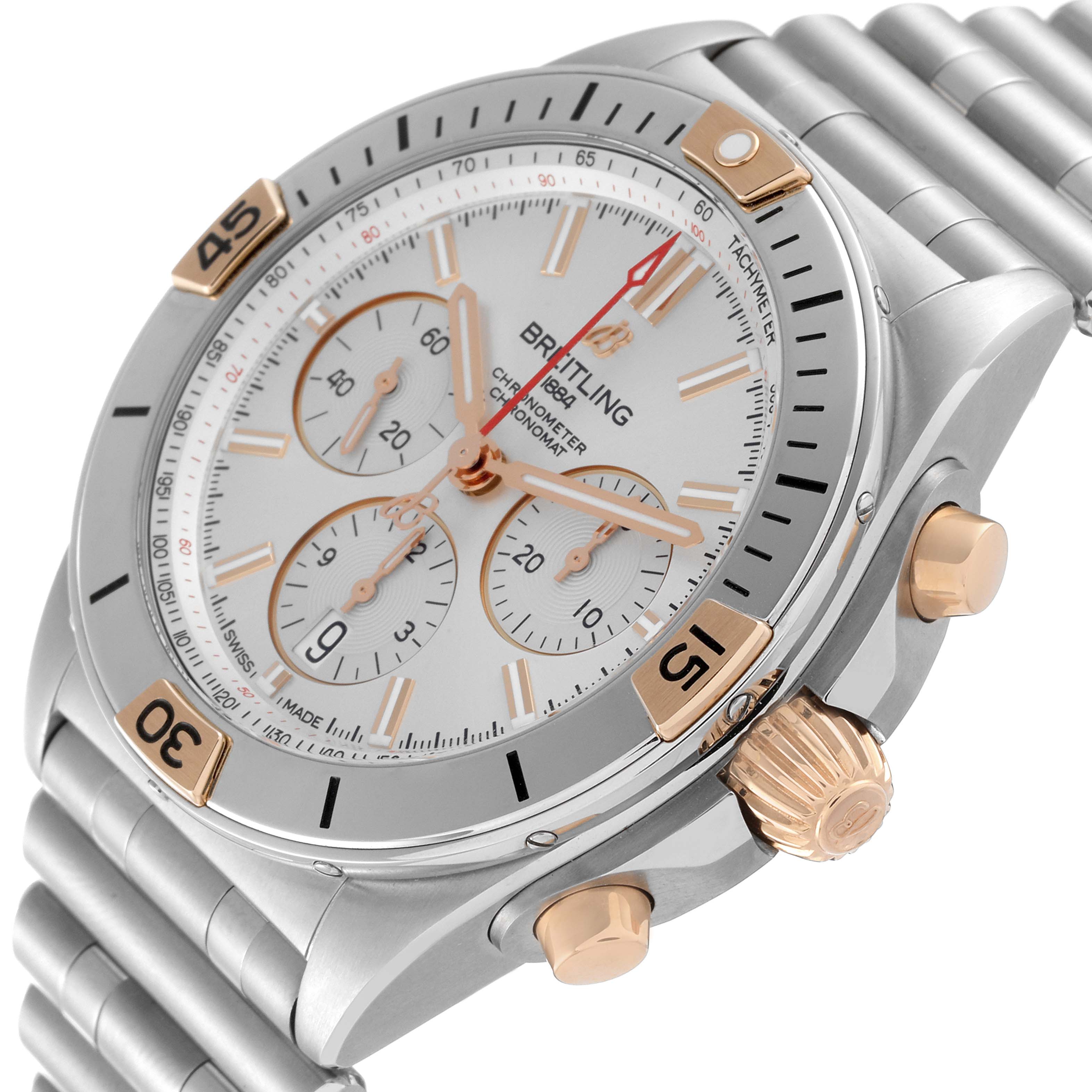 The image shows a close-up angle of a Breitling Chronomat IB0134 Men's Steel and Gold (two tone) Silver Dial IB0134 Men's Steel and Gold (two tone) Silver Dial watch, highlighting its face, bezel, pushers, and crown.