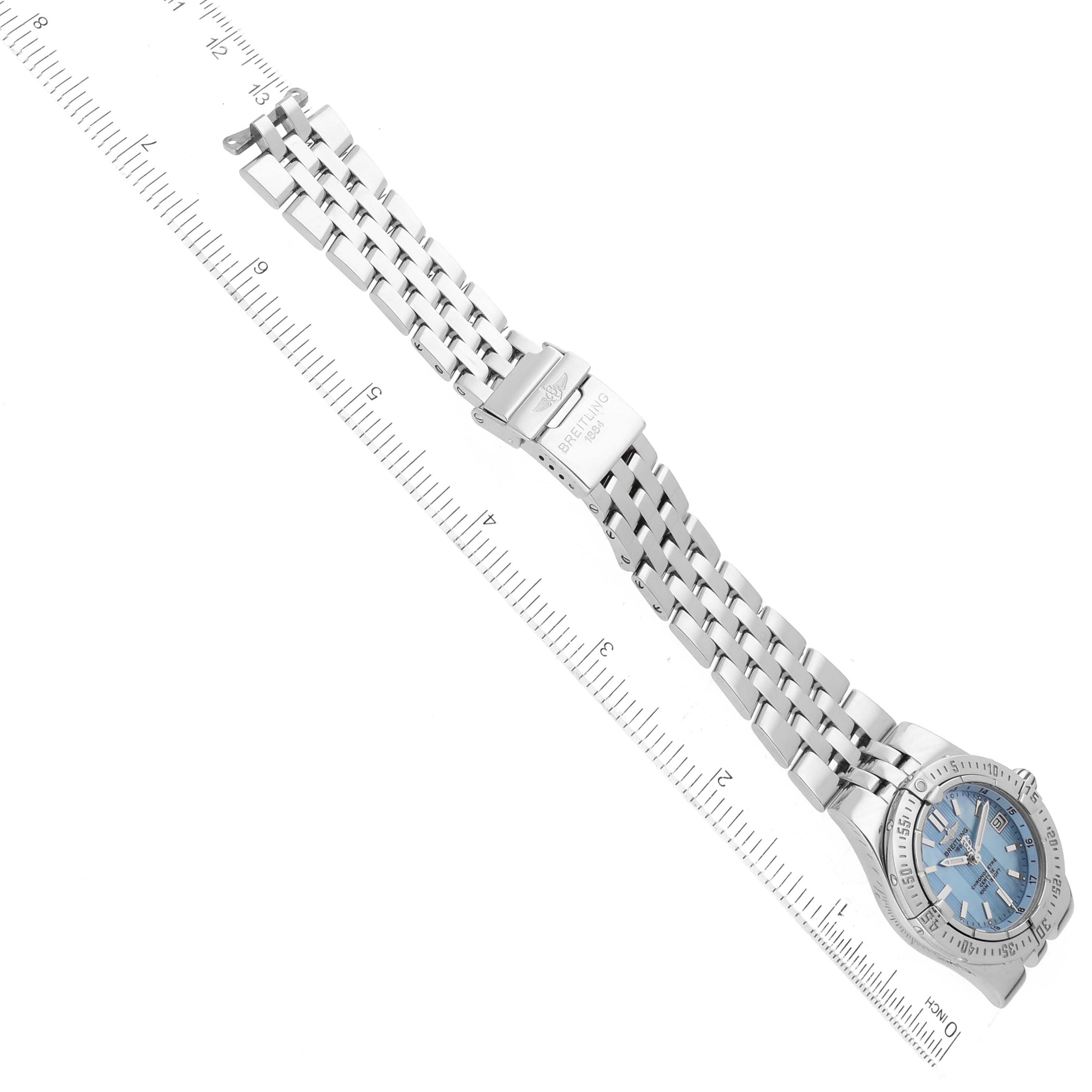 The image shows the Breitling A71340 Women
s Stainless Steel Mother of Pearl Dial A71340 Women
s Stainless Steel Mother of Pearl Dial Starliner Blue Mother of Pearl Dial Steel Ladies Watch A71340 laid flat with a ruler for scale.
