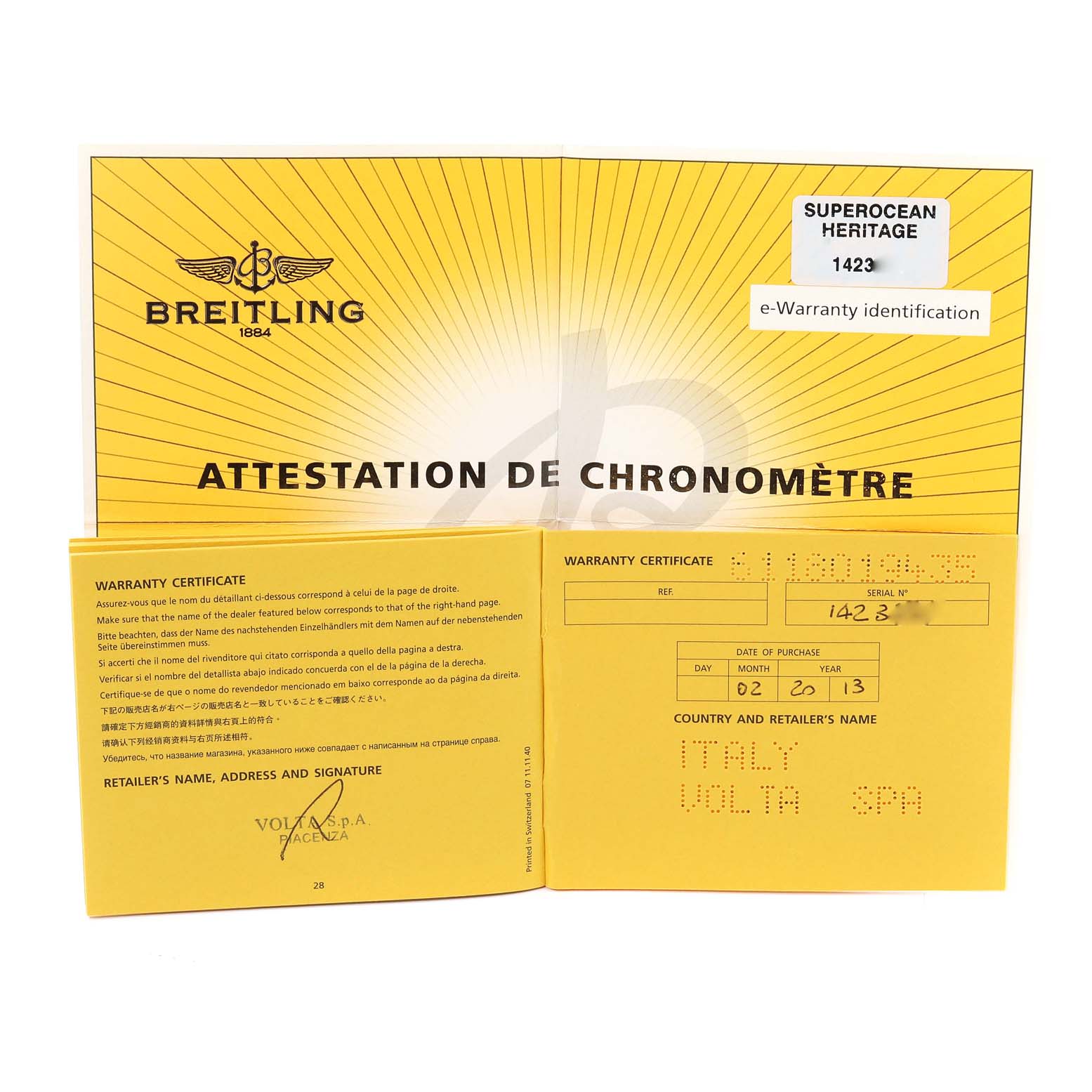 The image shows an open Breitling Attestation de Chronomètre booklet with warranty certificate for the Superocean Heritage model 1423.