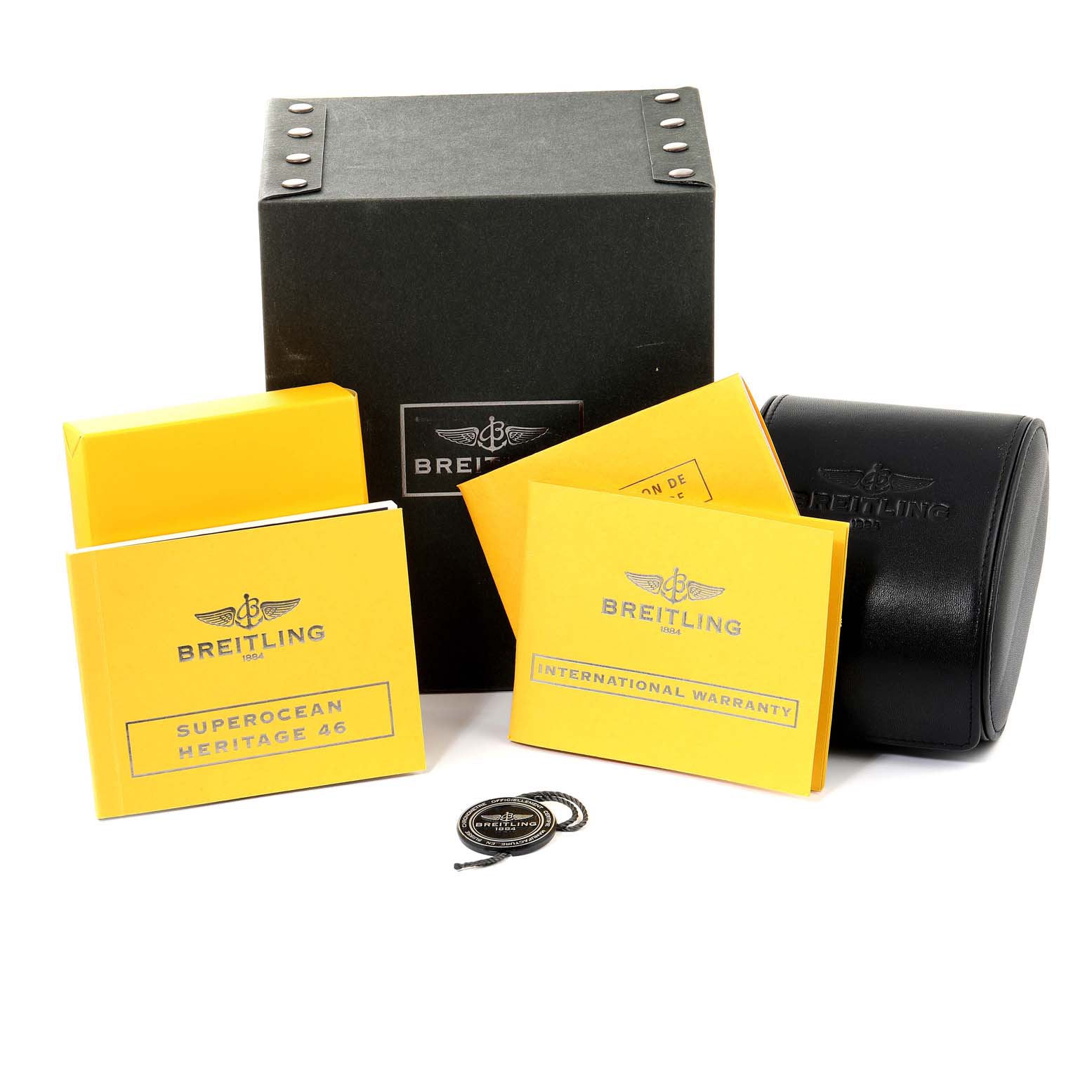 The image shows the packaging and accessories of a Breitling Superocean A17320 Men's Stainless Steel Black Dial A17320 Men's Stainless Steel Black Dial watch, including boxes, manuals, and a warranty card.