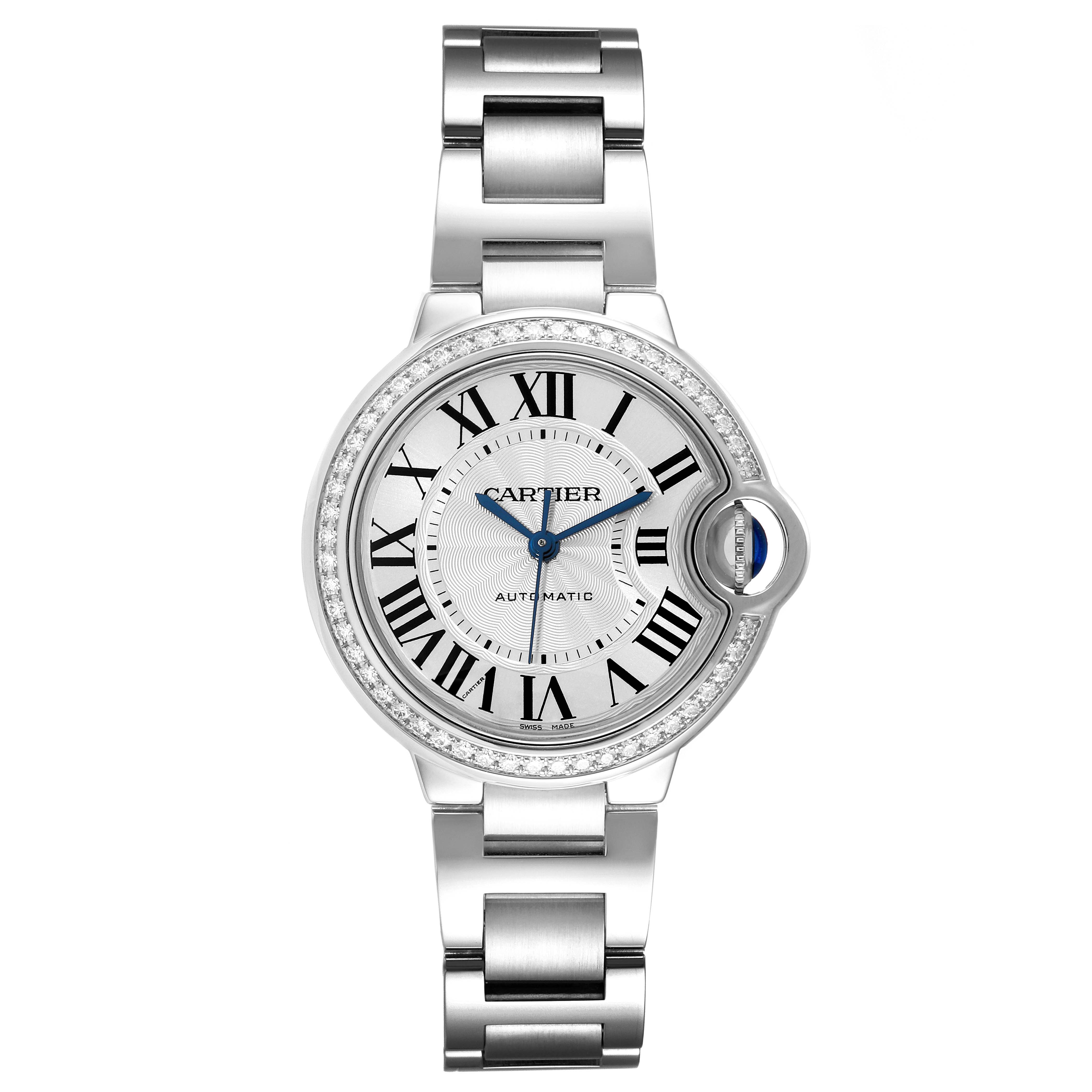 The image shows a top-down view of the Ballon Bleu by Cartier, detailing its face, roman numerals, and metal bracelet.