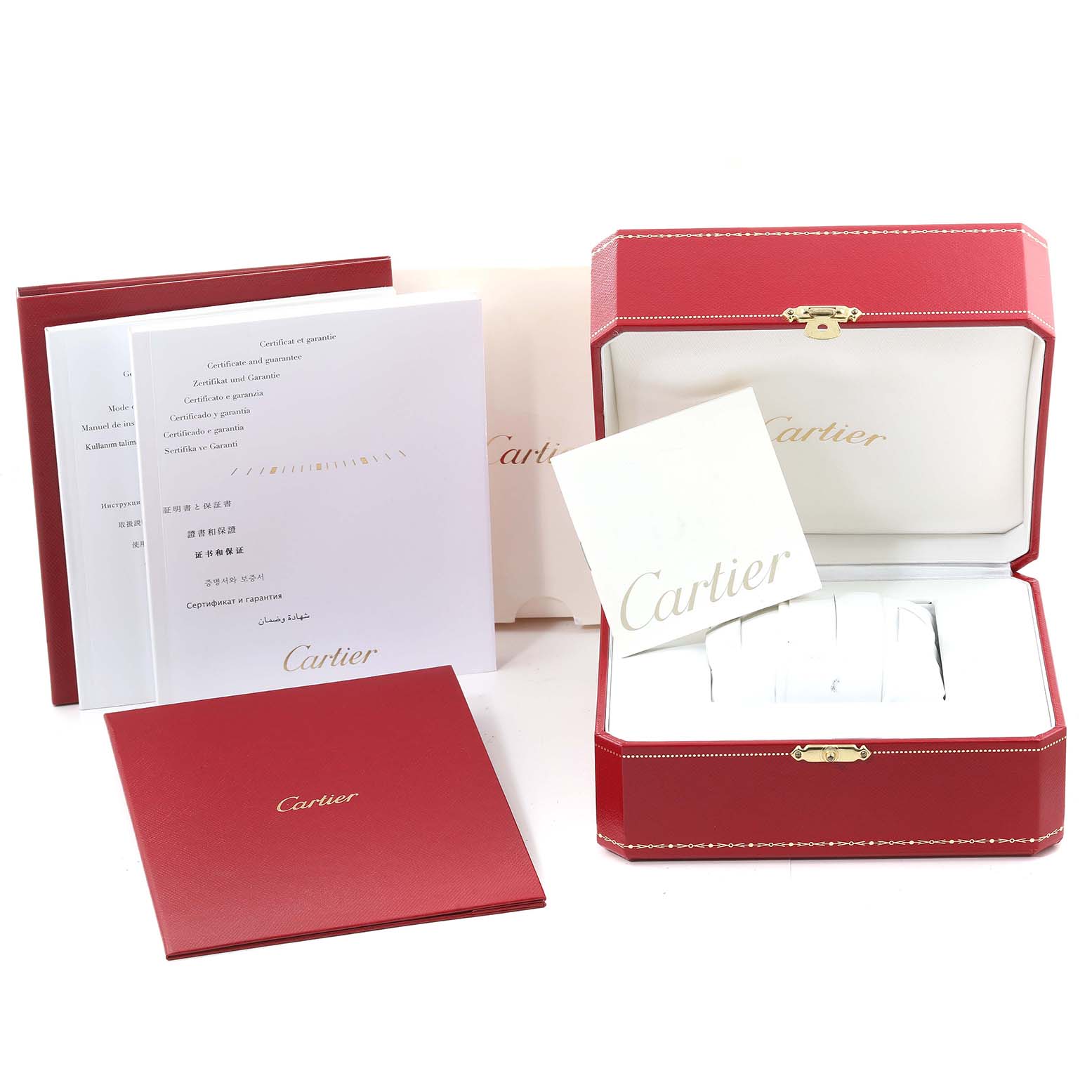 The image shows the packaging and documentation for a Calibre de Cartier watch by Cartier, including the red box and warranty booklets.